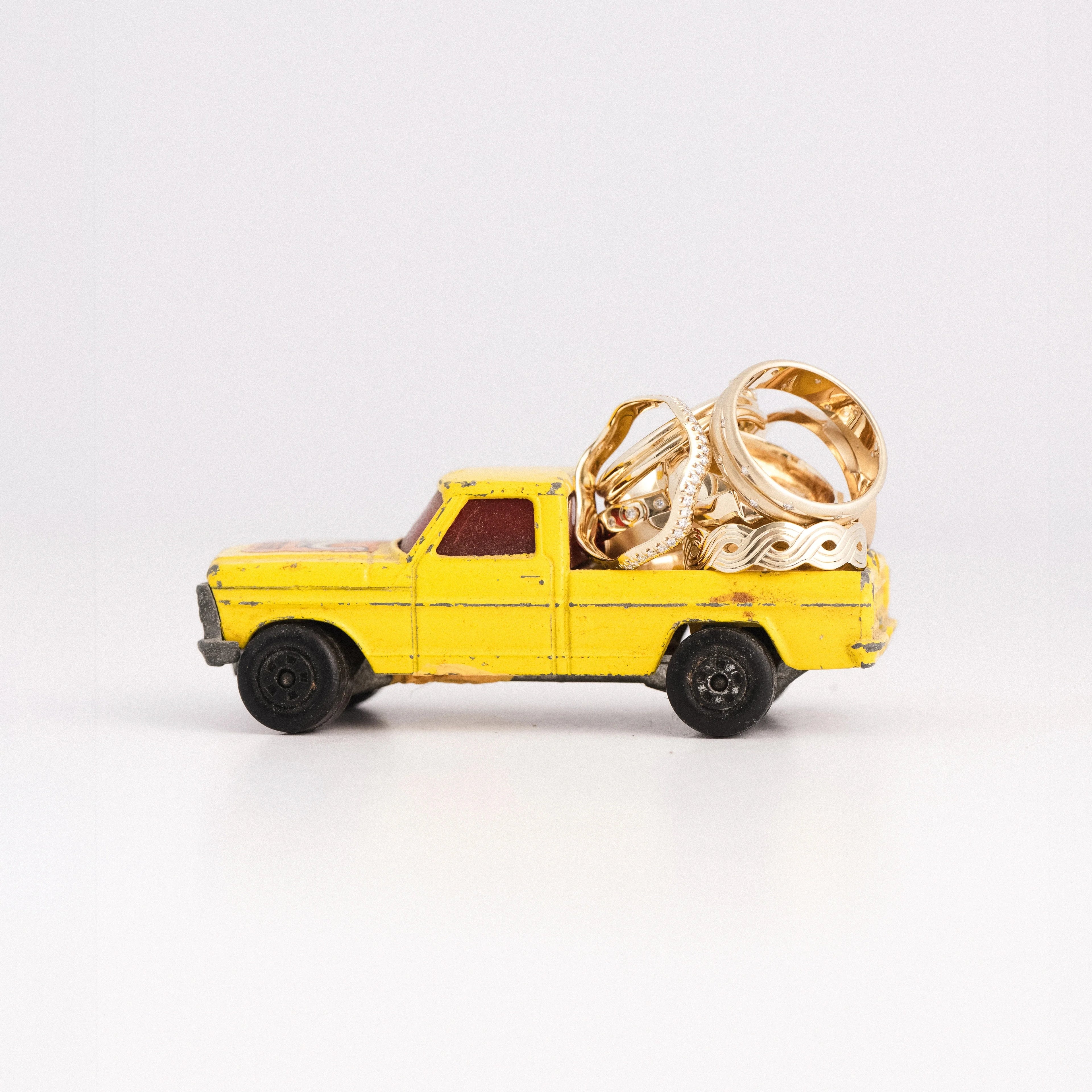 yellow truck filled with solid gold rings