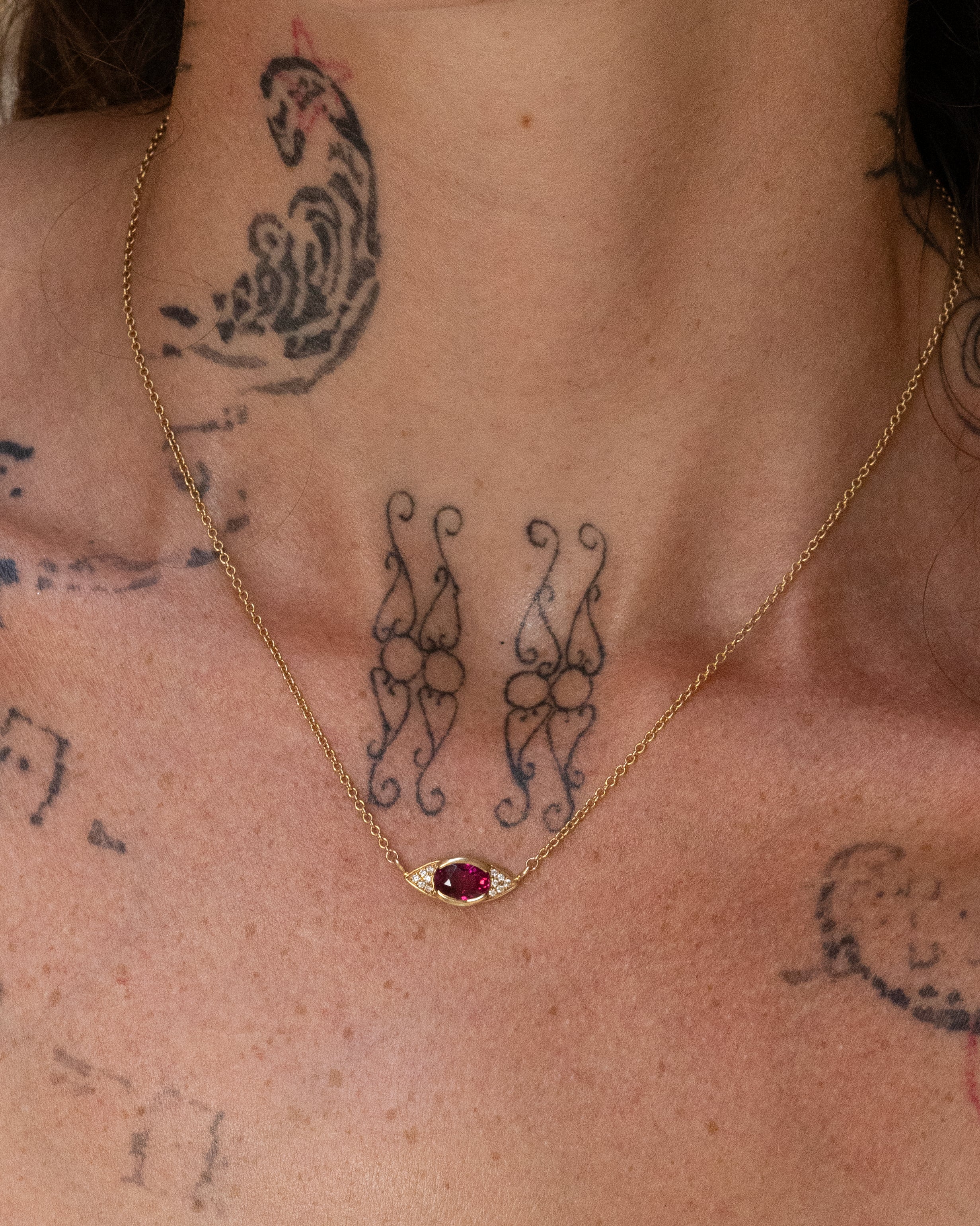 The Pupil Pendant, a solid 14k gold necklace featuring a 1.7-carat oval-cut pink tourmaline and lab-grown white diamonds. The delicate rolo chain and eye-shaped pendant create a quietly radiant and unique look