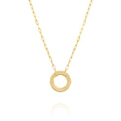 A solid 14k gold necklace featuring a paperclip link chain and a circular pendant with intricate engraved details. The polished gold chain measures 50mm in length, adding a modern yet timeless elegance to the design.