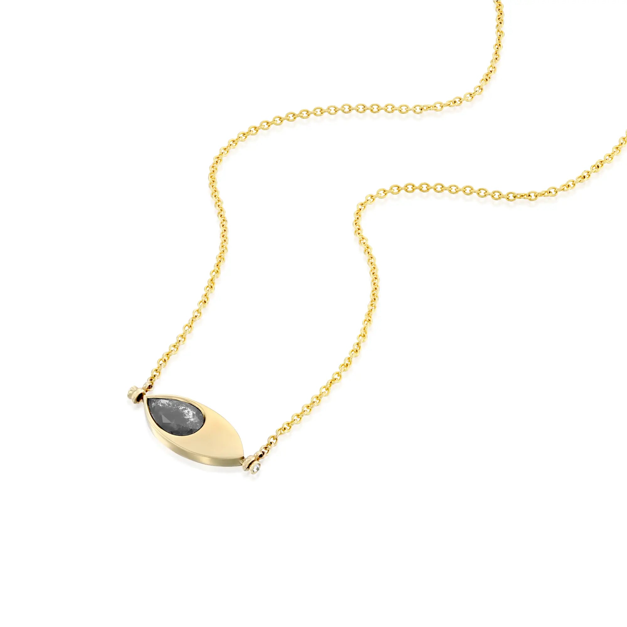 A solid 14k gold pendant necklace featuring a 1.64-carat pear-cut natural salt-and-pepper diamond set in an eye-shaped bezel. The design includes two 1.5mm round white diamonds and a 50mm rolo chain. The unique salt-and-pepper diamond showcases natural inclusions, making this piece one-of-a-kind.