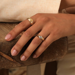 A symbol of enduring love, this engagement ring is adorned with a 0.3ct natural Asscher-cut diamond, radiating timeless elegance. Photographed in solid 14k gold, its band gracefully tapers from ~2mm to 5.5mm, creating a delicate yet striking design that beautifully captures life's most magical moments. 